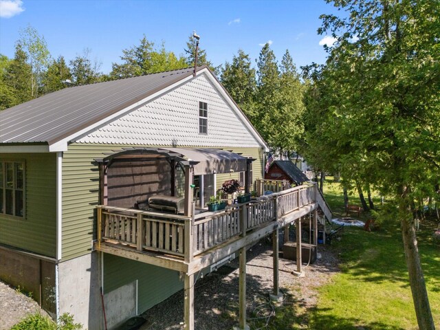 32 Whites Pond Rd, Palmyra, ME 04965 - rear view of property featuring a deck, metal roof, and a lawn