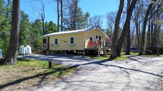 view of side of home with a deck and stairs