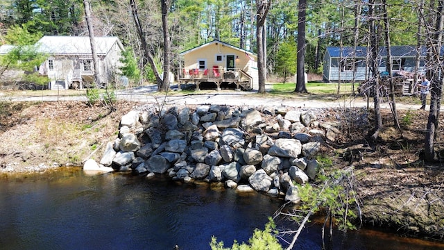 view of yard with a deck with water view