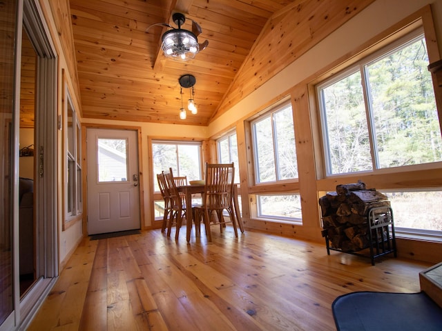 sunroom / solarium featuring vaulted ceiling