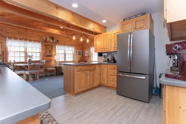 107 Elm St, Farmington, ME 04938 - kitchen featuring a peninsula, beam ceiling, freestanding refrigerator, light wood-style flooring, and light brown cabinetry