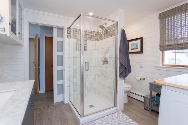 107 Elm St, Farmington, ME 04938 - bathroom featuring vanity, ornamental molding, wood finished floors, and a baseboard heating unit
