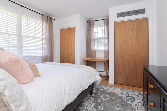 107 Elm St, Farmington, ME 04938 - bedroom featuring a baseboard heating unit and light wood finished floors