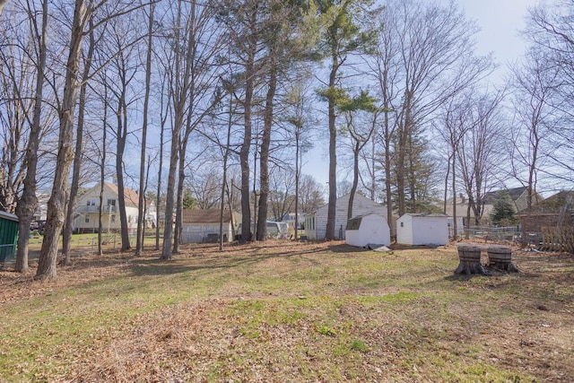107 Elm St, Farmington, ME 04938 - view of yard featuring fence, a shed, and an outdoor structure