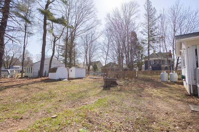 107 Elm St, Farmington, ME 04938 - view of yard featuring a storage shed, an outdoor structure, and fence