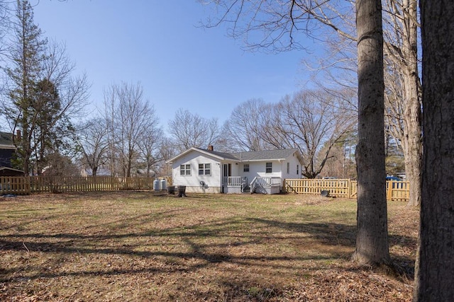 107 Elm St, Farmington, ME 04938 - bungalow featuring a chimney, a deck, a front yard, and fence