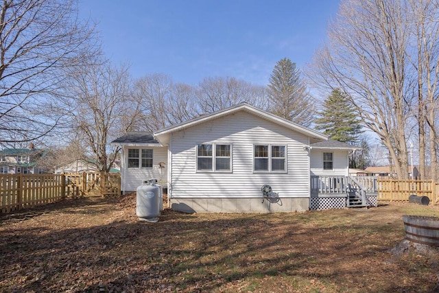 107 Elm St, Farmington, ME 04938 - back of house featuring a wooden deck and a fenced backyard