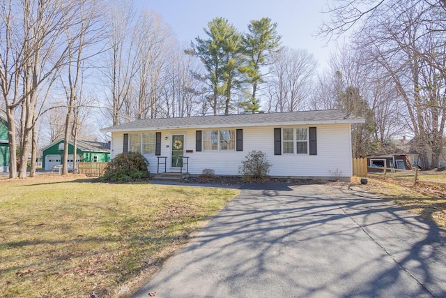 107 Elm St, Farmington, ME 04938 - ranch-style house featuring a front lawn and aphalt driveway