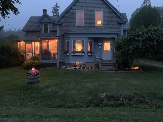 412 N Lubec Rd, Lubec, ME 04652 - view of front of property featuring a front lawn, roof with shingles, and a chimney