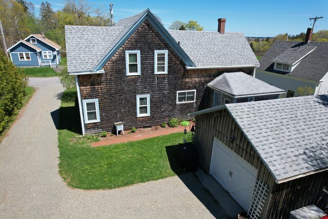 412 N Lubec Rd, Lubec, ME 04652 - view of side of property with a chimney, a lawn, and a shingled roof