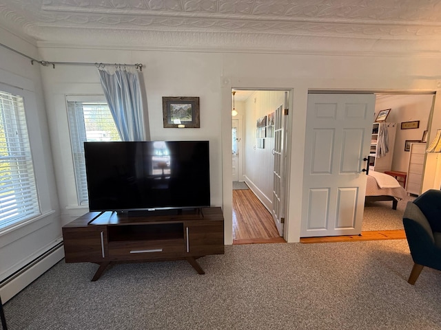 412 N Lubec Rd, Lubec, ME 04652 - living area with a baseboard heating unit, carpet floors, and ornamental molding