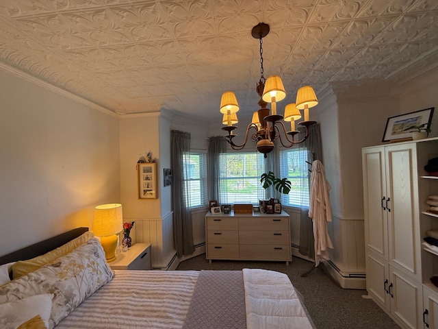 412 N Lubec Rd, Lubec, ME 04652 - bedroom featuring a chandelier, an ornate ceiling, crown molding, dark colored carpet, and a baseboard radiator