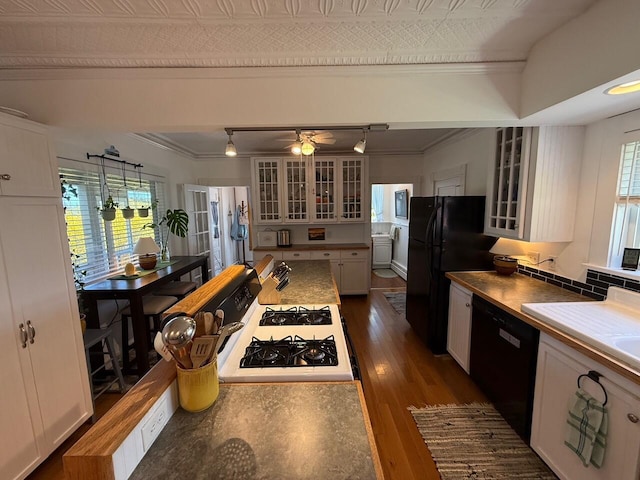 412 N Lubec Rd, Lubec, ME 04652 - kitchen with black appliances, ornamental molding, plenty of natural light, white cabinets, and glass insert cabinets