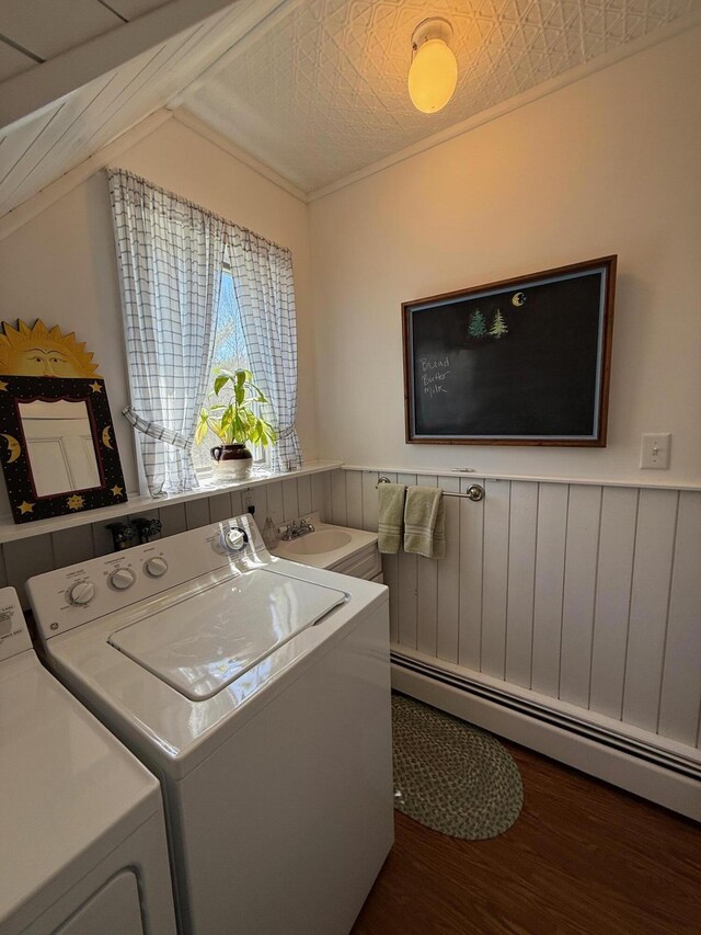412 N Lubec Rd, Lubec, ME 04652 - laundry room featuring washer and dryer, a baseboard heating unit, wood finished floors, and wainscoting