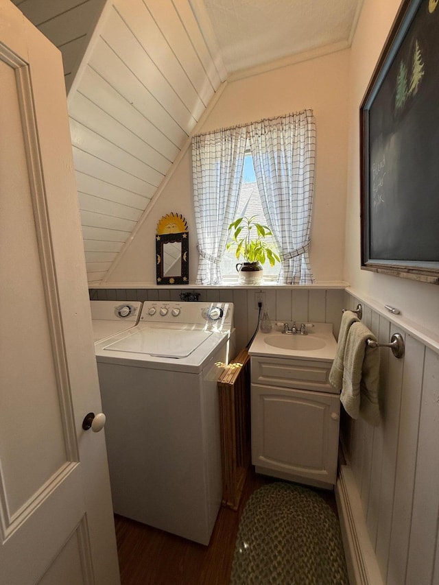 412 N Lubec Rd, Lubec, ME 04652 - laundry area featuring washer and dryer, dark wood-type flooring, cabinet space, and a wainscoted wall