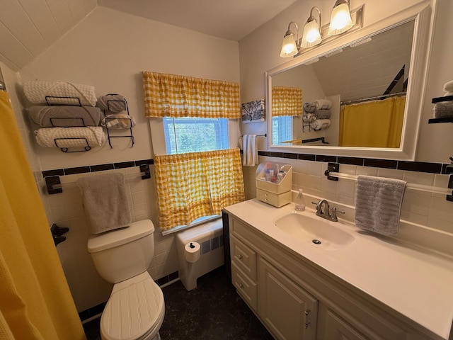 412 N Lubec Rd, Lubec, ME 04652 - bathroom with tile walls, toilet, vanity, radiator, and a wainscoted wall