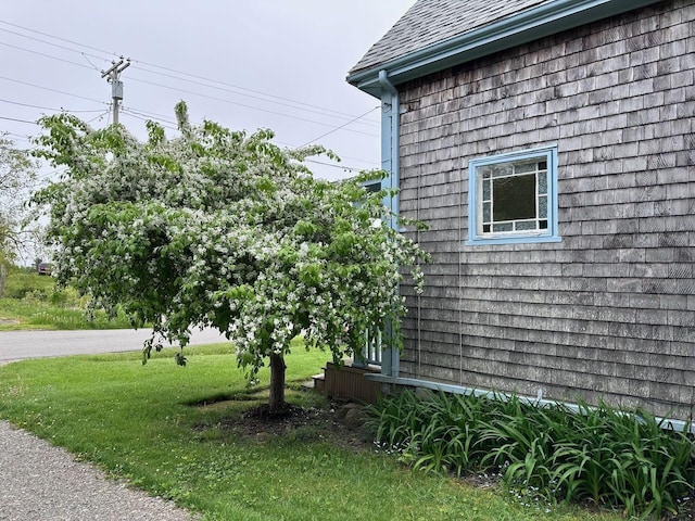 412 N Lubec Rd, Lubec, ME 04652 - view of side of home with roof with shingles and a yard