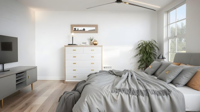 bedroom with a ceiling fan, visible vents, light wood-style flooring, and baseboards