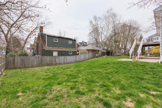 view of yard with a patio, stairway, a deck, and a fenced backyard