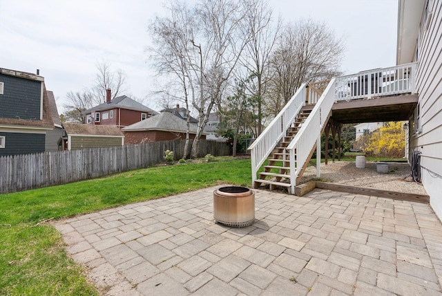 view of patio / terrace featuring an outdoor fire pit, a deck, stairway, and a fenced backyard