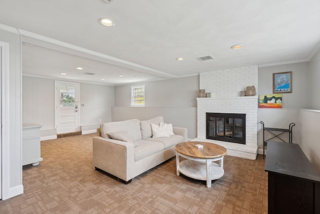 living room with crown molding, visible vents, a fireplace, and recessed lighting