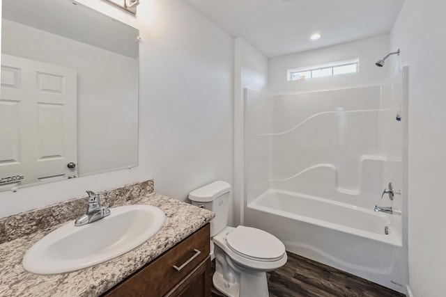 255 Cushing Rd, Cushing, ME 04863 - bathroom with vanity, toilet, shower / washtub combination, and wood finished floors