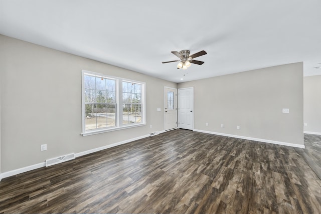 255 Cushing Rd, Cushing, ME 04863 - unfurnished living room featuring dark wood-style floors, ceiling fan, and baseboards