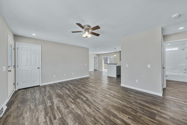 255 Cushing Rd, Cushing, ME 04863 - unfurnished living room with a ceiling fan, dark wood-style flooring, baseboards, and recessed lighting