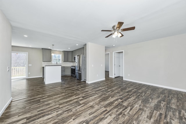 255 Cushing Rd, Cushing, ME 04863 - unfurnished living room featuring dark wood-style flooring, ceiling fan, baseboards, and recessed lighting
