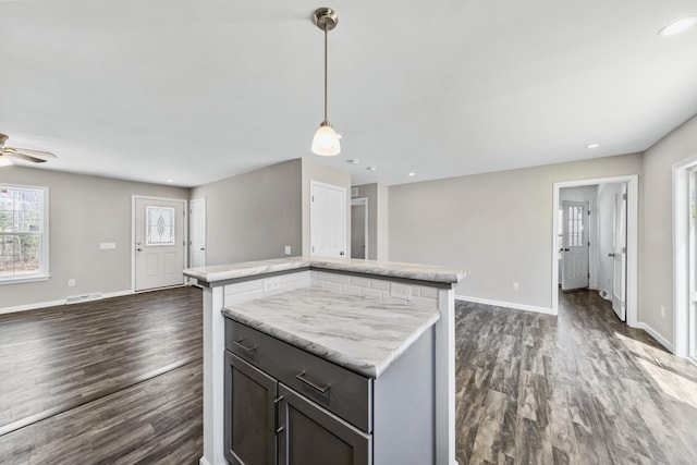 255 Cushing Rd, Cushing, ME 04863 - kitchen featuring open floor plan, a kitchen island, baseboards, dark wood-type flooring, and recessed lighting