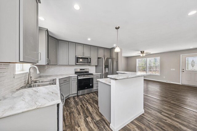 255 Cushing Rd, Cushing, ME 04863 - kitchen with appliances with stainless steel finishes, a sink, gray cabinetry, backsplash, and recessed lighting