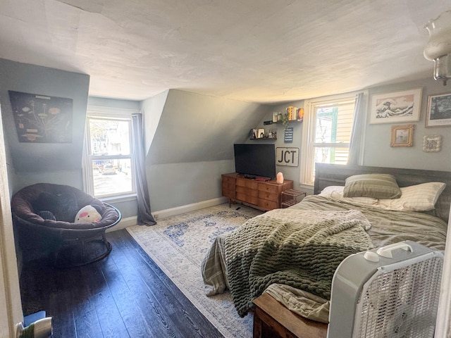 6 Hudson St, Bangor, ME 04401 - bedroom with multiple windows, baseboards, lofted ceiling, and hardwood / wood-style flooring