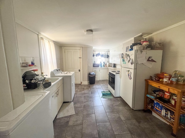 6 Hudson St, Bangor, ME 04401 - kitchen with white cabinets, washing machine and dryer, light countertops, and white appliances