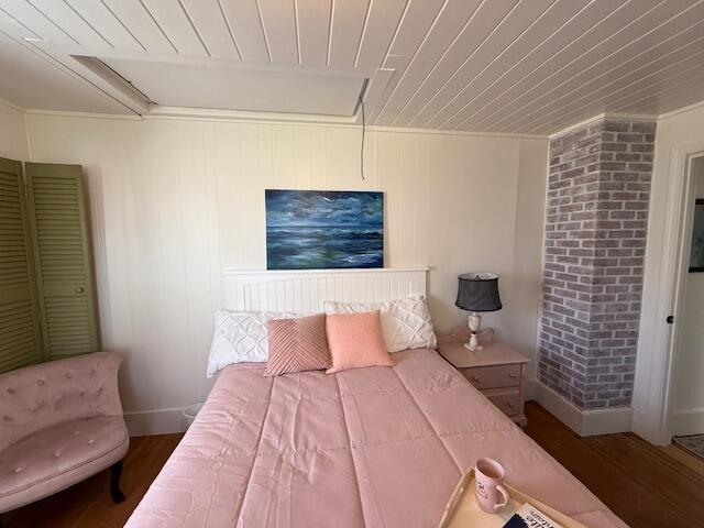7 Johnson St, Eastport, ME 04631 - bedroom featuring wooden ceiling, attic access, baseboards, and wood finished floors