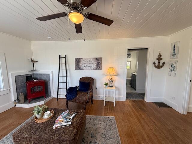 7 Johnson St, Eastport, ME 04631 - living room with baseboards, a wood stove, wood ceiling, and wood finished floors