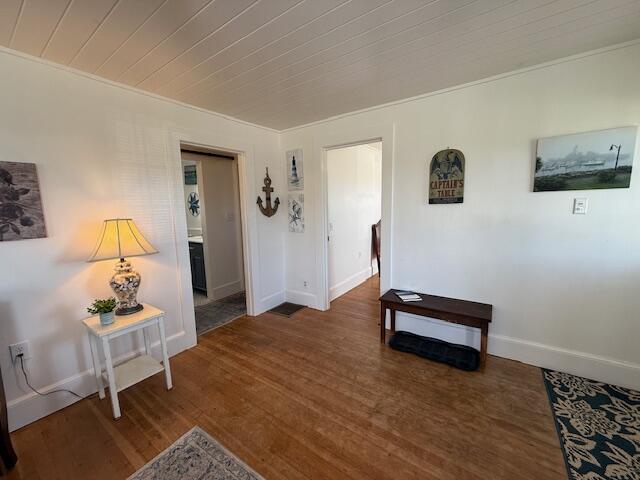 7 Johnson St, Eastport, ME 04631 - hall featuring crown molding, wood finished floors, and baseboards