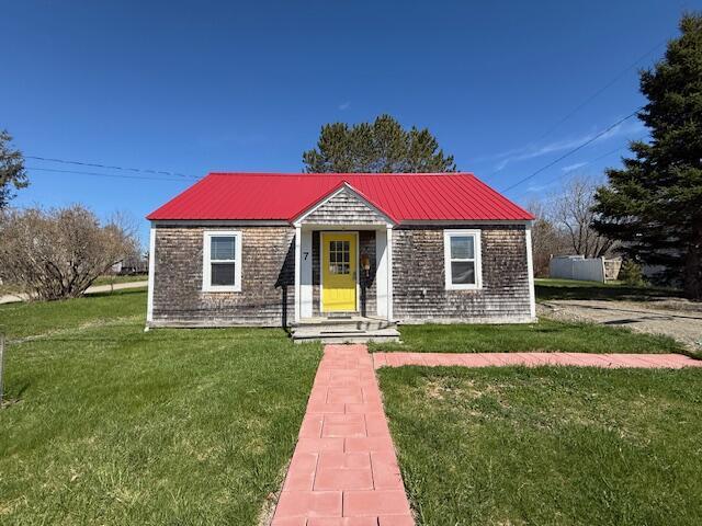 7 Johnson St, Eastport, ME 04631 - bungalow-style home with metal roof and a front lawn