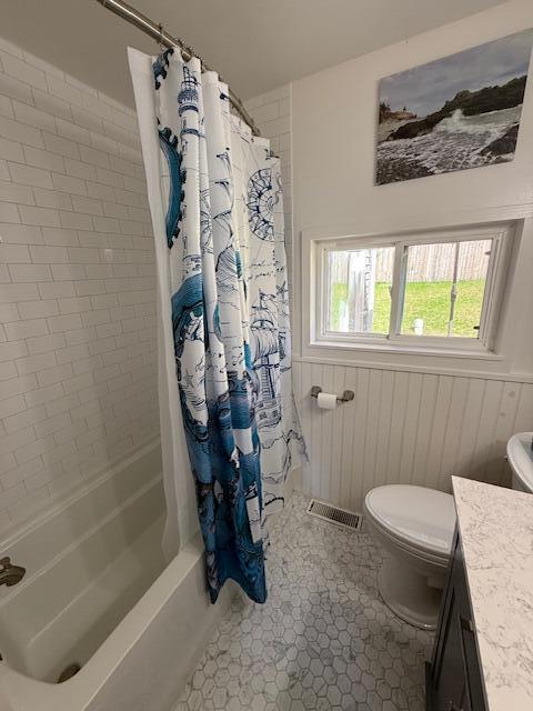 7 Johnson St, Eastport, ME 04631 - full bathroom featuring toilet, visible vents, vanity, a wainscoted wall, and shower / bath combo