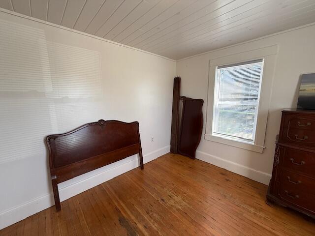7 Johnson St, Eastport, ME 04631 - bedroom with wooden ceiling, baseboards, and wood finished floors