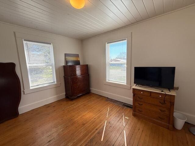 7 Johnson St, Eastport, ME 04631 - bedroom featuring crown molding, wood ceiling, baseboards, and light wood-style floors