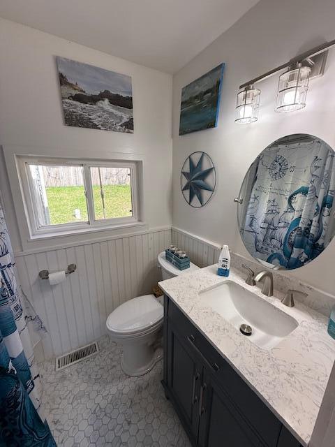 7 Johnson St, Eastport, ME 04631 - full bathroom with vanity, toilet, visible vents, and wainscoting