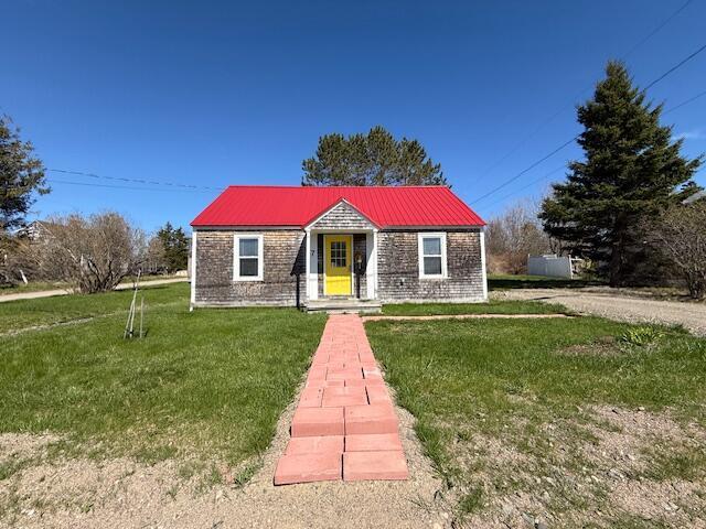7 Johnson St, Eastport, ME 04631 - bungalow-style house with a front lawn and metal roof