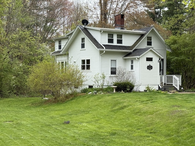 8 Organug Rd, York, ME 03909 - back of house with a chimney, a lawn, a shingled roof, and view of wooded area
