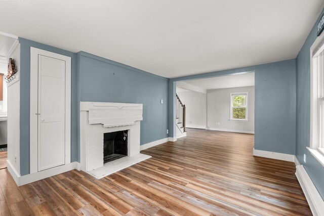 8 Organug Rd, York, ME 03909 - unfurnished living room featuring stairway, wood finished floors, baseboards, and a fireplace