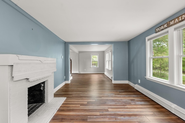 8 Organug Rd, York, ME 03909 - unfurnished living room with baseboard heating, baseboards, wood finished floors, and a fireplace