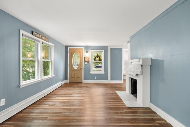 8 Organug Rd, York, ME 03909 - unfurnished living room with baseboard heating, a brick fireplace, wood finished floors, and baseboards