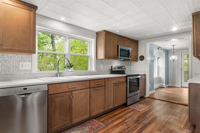 8 Organug Rd, York, ME 03909 - kitchen with appliances with stainless steel finishes, a sink, dark wood finished floors, backsplash, and light countertops