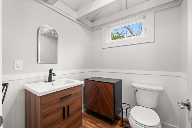 8 Organug Rd, York, ME 03909 - half bathroom featuring wainscoting, toilet, vanity, and wood finished floors