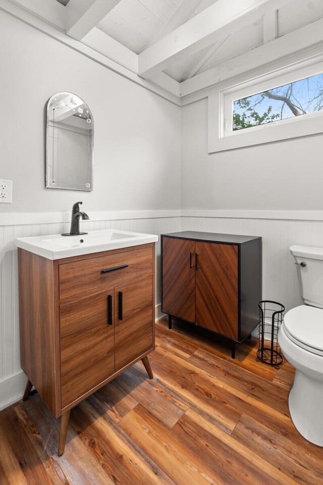 8 Organug Rd, York, ME 03909 - bathroom with toilet, vanity, wood finished floors, and a wainscoted wall