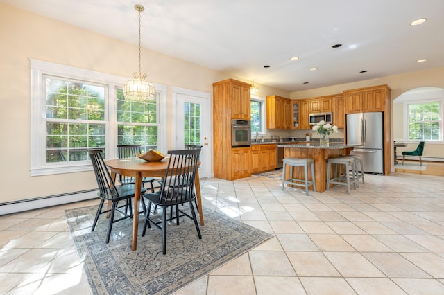 148 Hunter Way, Falmouth, ME 04105 - dining room with arched walkways, baseboard heating, light tile patterned flooring, and recessed lighting